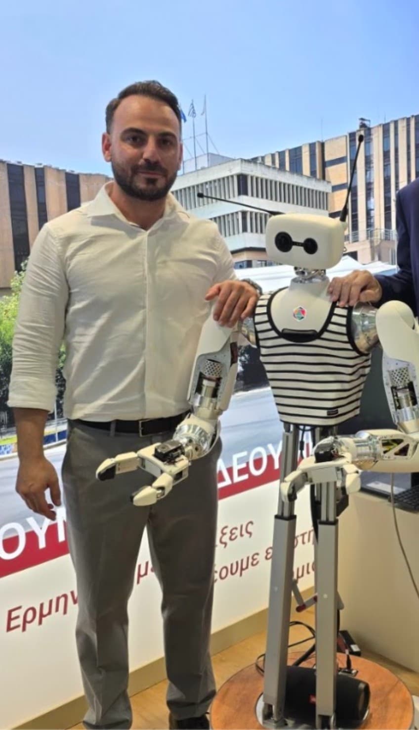 Theofilos Papadopoulos with the Reachy humanoid robot at the University of Macedonia stand, ΔΕΘ 2026